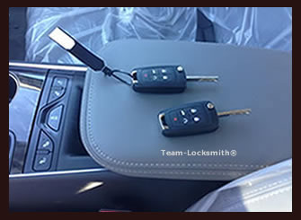 two new car keys sitting on dashboard